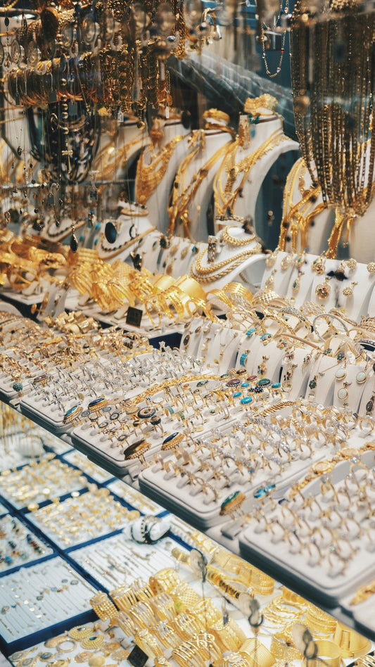 Wholesale gold jewelry collection with rings, necklaces, and bracelets for resale in a jewelry business